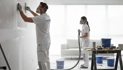 Painter repairing drywall cracks in Lynchburg, VA home for seamless wall restoration and smooth finish