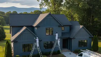 Professional house painters in Lynchburg VA applying exterior paint to a residential home façade